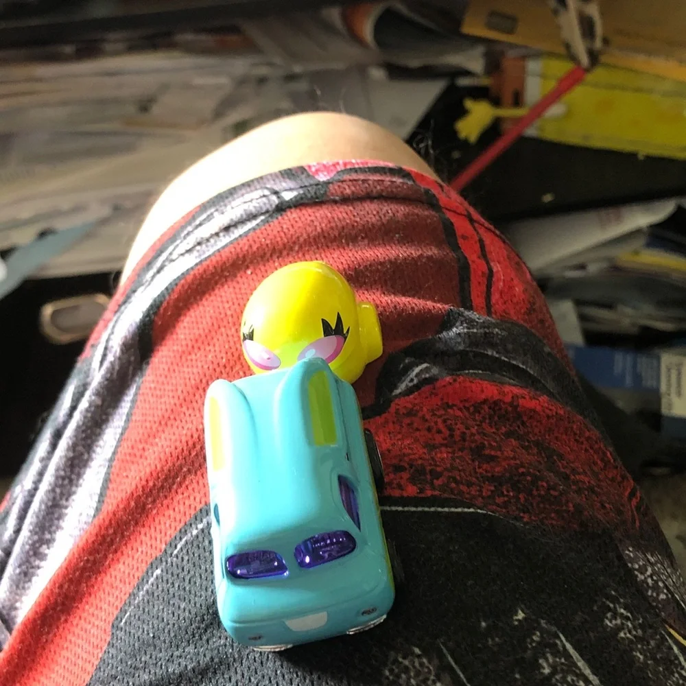 Bright Turquoise Toy Car with Yellow Character